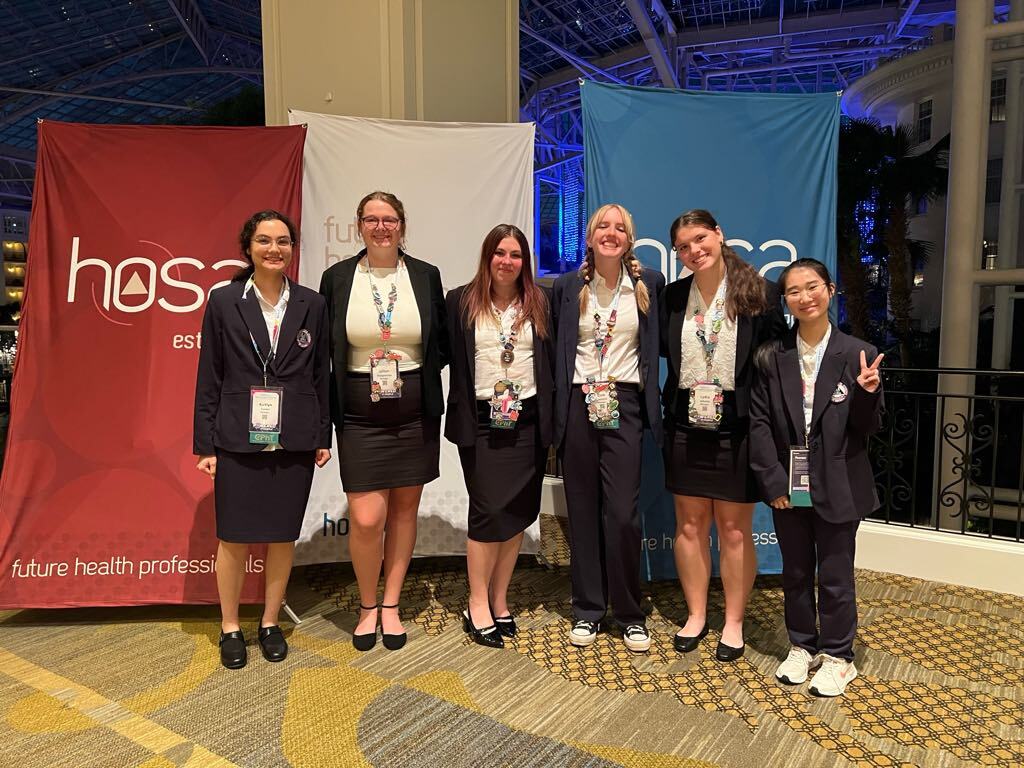 Six female KCTC students pose in front of HOSA sign in Nashville.